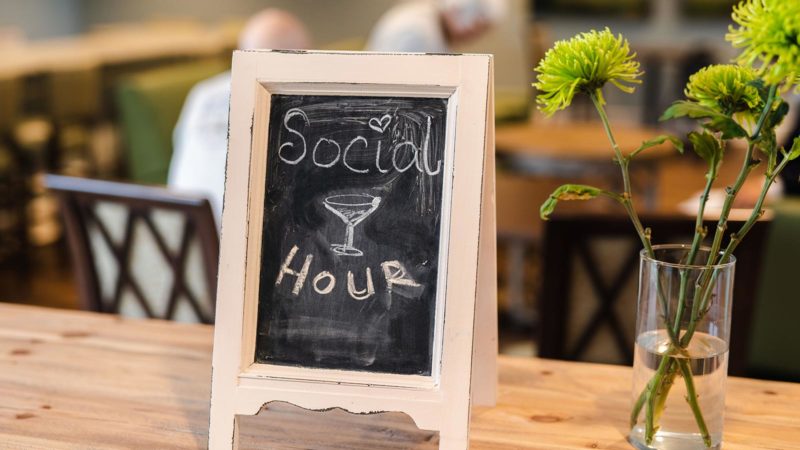 Chalkboard sign with Social Hour written on it